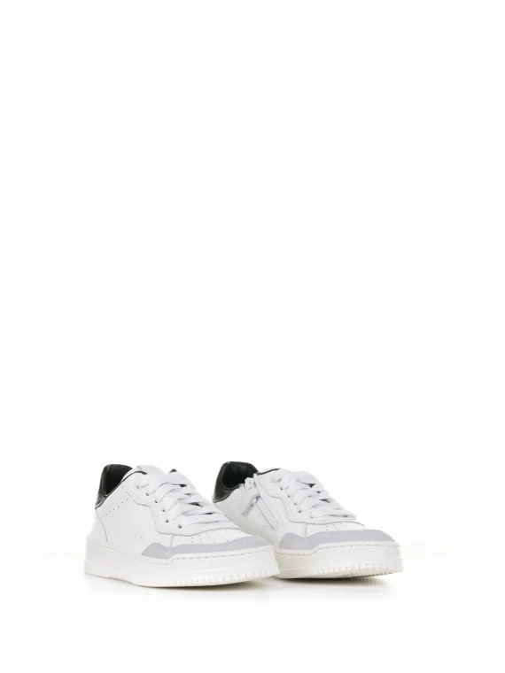 White leather sneaker with black heel