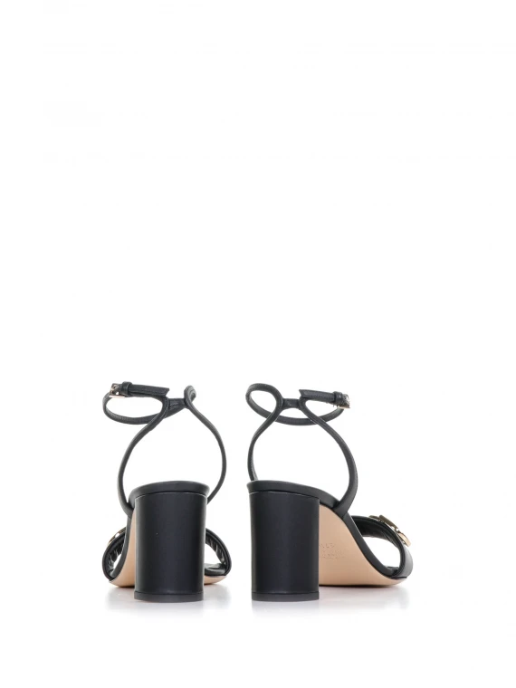 Sandal with heel and strap