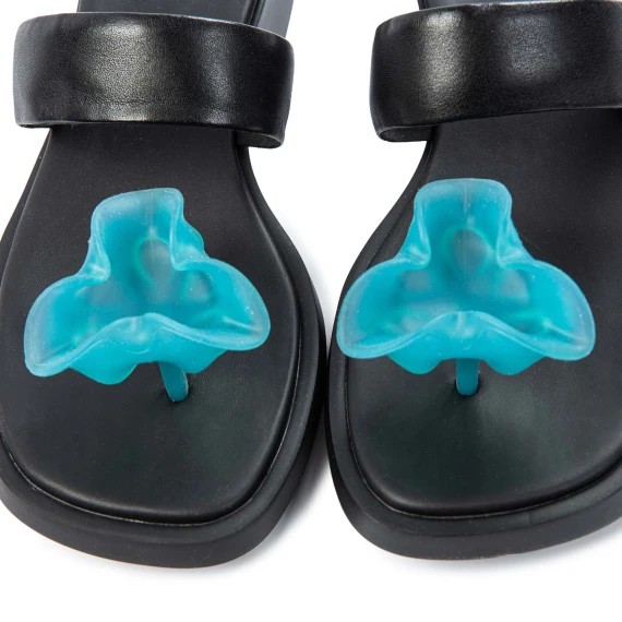 black flip flops with light blue flower